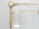 a glass shelf with a mirror on top of it