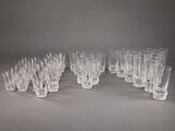 set of twelve crystal wine glasses on a grey background