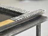 a close up of a piece of metal on a table
