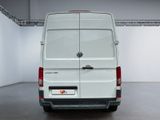 the back of a white van parked inside of a building
