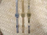 two watches that are sitting on a woven basket