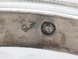an image of a close up of a silver plate on a table