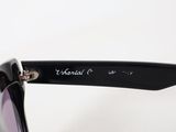 the sunglasses are black and have a metal bar at the top of the frame