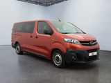 the red van is parked in a large room with a black floor
