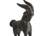 a small statue of a goat with horns on it ' s head