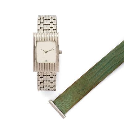 an image of a watch and a green strap on a white surface