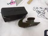 a black box and a black hair clip on a white t - shirt