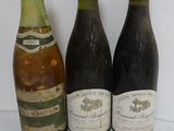 three bottles of wine sitting next to each other on a table