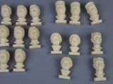 a lot of white marble busts on display on a table