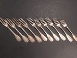 a set of six forks and spoons sitting on a table