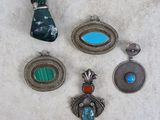 a close up of a group of jewelry on a table
