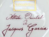 an image of a white plate with a gold border and a name on it