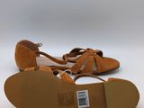 the back of a pair of women ' s tan sandals on a white background