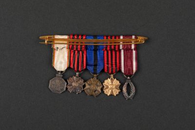 a close up of a medal and a pen on a black surface