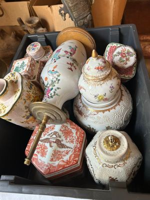 a box full of different types of vases on a table