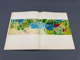 an open book with a picture of a landscape on it
