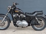 a black motorcycle parked in front of a garage door