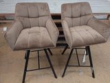 two chairs that are sitting next to each other on a table