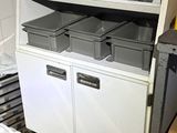 many bins on the shelves in the room