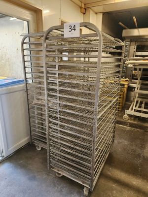 a large metal rack with many trays of food on it