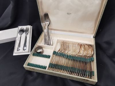 a box with silverware in it on a black cloth