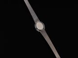 a close up of a wrist watch on a black background