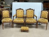 four chairs and a ottoman in the middle of a room
