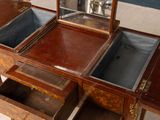 a wooden vanity with a mirror on top of it