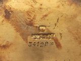 a close up of a gold plate with a stamp on it