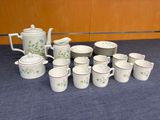 a lot of coffee cups and saucers on the table