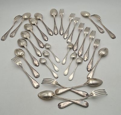 a lot of silver spoons and forks arranged in a circle