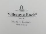 a close up of a white plate with a black and white logo