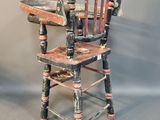 a wooden chair that has been painted black and red