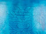 a large blue vase with a floral design on it