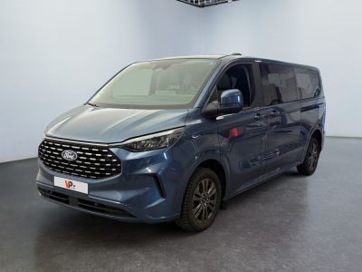 a blue van is parked in a large room with a black floor