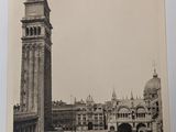 a black and white photo of a clock tower in the middle of a city