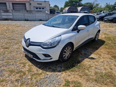a white car parked in a lot with a lot of cars in the background