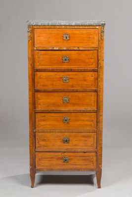 a small wooden chest of drawers with marble top