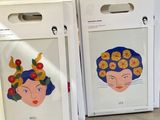 boxes with drawings of a woman ' s face on them sitting on a table