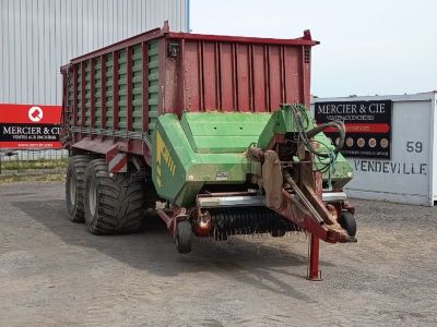 a tractor that is parked in front of a building