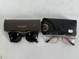 pair of glasses and case sitting on a table next to a pair of glasses