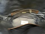 the inside of a black leather purse with a gold handle