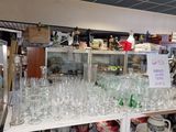 many glasses and plates on the shelves in the store