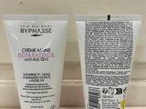 two tubes of creams sitting on a counter next to each other
