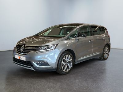 a silver van parked in a room with a black floor