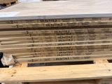 several stacks of wood are stacked on top of each other in a warehouse