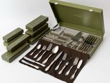a green case with silverware in it on a white surface