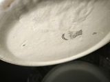 a close up of a white plate with a bird on it