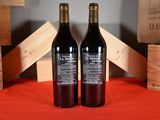 two bottles of wine sitting next to each other on a table