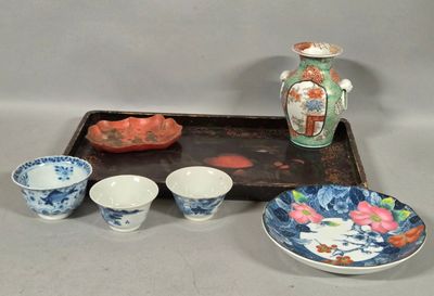 a tray with bowls and a tray with a vase on it